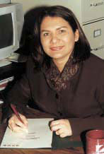 Elosia Echavez sitting and writing.