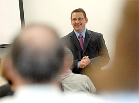 Picture of a student talking before a group.